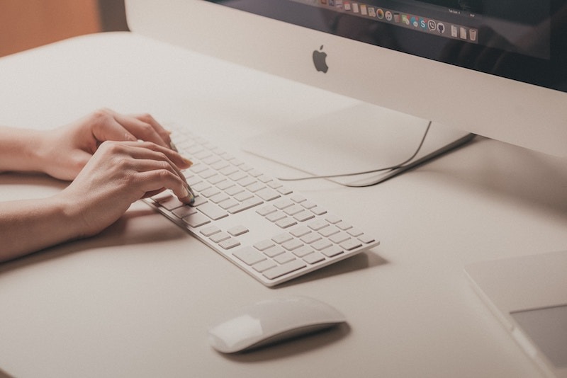 Hands Typing On Apple Mac Computer Keyboard