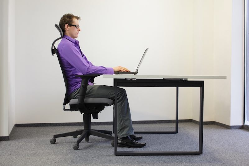 Man using an ergonomic chair to improve posture