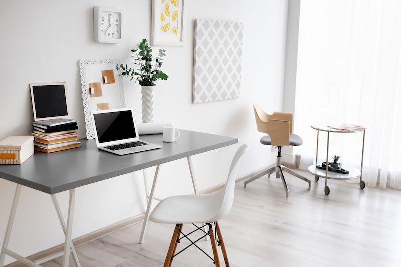 Simple minimal office with a white chair and office plants